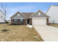 Brick and gray siding ranch home with attached garage and landscaped lawn at 5486 W Woodhaven Dr, McCordsville, IN 46055