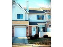 Charming townhome featuring a brick facade, attached garage, and well-maintained landscaping at 5914 Mornay Dr, Indianapolis, IN 46254