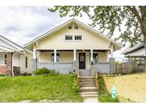 Charming craftsman home featuring a covered front porch, fresh paint, and landscaped front yard at 1206 Comer Ave, Indianapolis, IN 46203