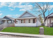 Charming craftsman home with a gray exterior and well-manicured lawn at 1411 Lawton Ave, Indianapolis, IN 46203