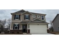 Charming two-story home with a two-car garage, black shutters, and brick accents at 1544 Covington Blvd, Franklin, IN 46131