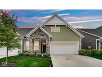 Charming craftsman style home with stone accents and a two-car garage at 17083 Cole Evans Dr, Noblesville, IN 46060