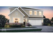 Two-story house with beige and brown siding, brick accents, and a two-car garage at 2112 Boxwood Dr, Greenfield, IN 46140