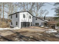 Lakefront property featuring two modern white houses with black accents at 459 W Lakeview Dr, Nineveh, IN 46164