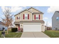 Two-story beige house with red shutters, a white garage door, and a well-maintained lawn at 5772 Weeping Willow Pl, Whitestown, IN 46075