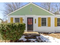 Charming renovated home with green and white exterior, and a welcoming front porch at 6602 Caroline Ave, Indianapolis, IN 46220