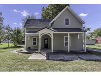 Charming gray house with a metal roof and front porch at 7077 E Mulberry St, Gwynneville, IN 46144