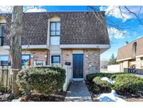 Brick townhouse with dark brown roof and a small front yard at 7368 Countrybrook Dr # 7368, Indianapolis, IN 46260