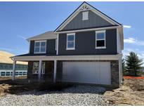 Two-story home featuring gray siding, white trim, and a two-car garage with stone accents on the lower level at 7541 Big Bend Blvd, Camby, IN 46113