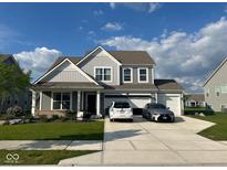 Charming two-story home boasts a three car garage, and a beautifully landscaped front yard, creating curb appeal at 9426 Orchard Cove Dr, Indianapolis, IN 46239