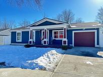 Ranch home with blue siding, white trim, and a burgundy garage door at 9519 Meadowlark Dr, Indianapolis, IN 46235