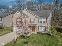 Charming two-story home featuring brick accents, red shutters, well-manicured lawn, and a 'For Sale' sign on the front yard at 10391 Butler Dr, Brownsburg, IN 46112