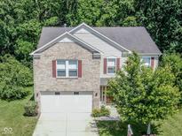 Charming two-story home with a brick facade, attached two-car garage, and nicely landscaped front yard at 10391 Butler Dr, Brownsburg, IN 46112