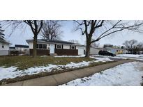 Brick ranch home with attached garage and mature trees in front yard at 11 Eastridge Dr, Greenwood, IN 46143