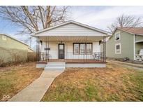Charming white house with a covered porch and walkway at 1616 Cincinnati Ave, Anderson, IN 46016