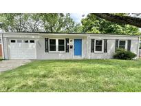 Brick ranch house with attached garage and landscaped lawn at 2533 Aurie Dr, Indianapolis, IN 46219