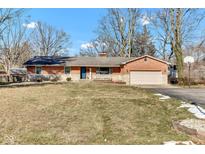 Brick ranch house with attached garage and landscaped yard at 3208 Shady Grove Ct, Indianapolis, IN 46222