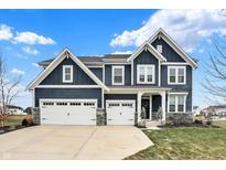 Two-story home with gray siding, white trim, and a three-car garage at 3572 Blenheim Pl, Westfield, IN 46074