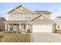 Two-story home featuring neutral siding, brick accents, covered front porch, and attached two-car garage at 366 Rocky Rd, Greenfield, IN 46140