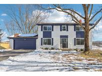 Two-story house with white brick, navy blue accents, and a spacious yard at 4155 Senour Rd, Indianapolis, IN 46239
