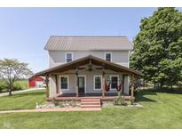 Charming two-story home with a covered front porch and mature trees offering a relaxing outdoor space at 5750 W 300 N Rd, Bargersville, IN 46106