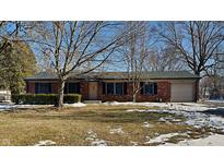 Brick ranch home with attached garage and landscaped yard at 5835 Downing Dr, Indianapolis, IN 46228