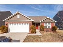 Brick ranch home with a two-car garage and landscaping at 6548 Emerald Crossing Way, Indianapolis, IN 46221