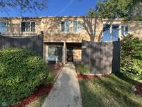 Tan-colored townhouse exterior with a wooden fence and walkway at 741 Ironwood Dr, Avon, IN 46123