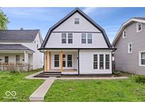 Charming two-story home with a modern design, large windows, inviting porch, and well-manicured lawn at 923 E Pleasant Run Pkwy S Dr, Indianapolis, IN 46203