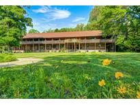 Spacious, rustic two-story home with a covered balcony and a beautifully landscaped front yard at 9600 N 500 E, Pendleton, IN 46064