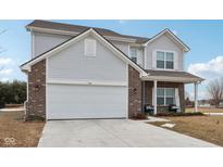 Two-story house with gray siding, brick accents, and a two-car garage at 1075 Galaxy Ln, Danville, IN 46122