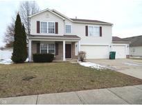 Traditional two-story home boasts a two-car garage and well-maintained landscaping, perfect for a Gathering at 1217 Legacy Ln, Indianapolis, IN 46234