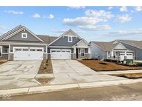 Charming two-story home featuring a two-car garage, and a well-manicured lawn, perfect for comfortable living at 16956 Cattle Hollow Ln, Noblesville, IN 46060