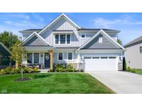 Two-story house with gray siding, white trim, and a stone facade at 19950 Chatham Green Dr, Westfield, IN 46074