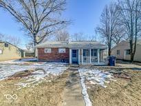 Brick ranch house with screened porch and mature trees at 2628 Crystal St, Anderson, IN 46012