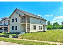 Two-story house with beige siding, a balcony, and a small front yard at 2913 Macpherson Ave, Indianapolis, IN 46205