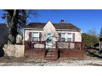 Quaint house with brown deck and purple shutters at 302 E Cowing Dr, Muncie, IN 47303