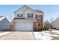 Two-story brick and siding house with a white garage door and red front door at 5243 Montavia Ln, Indianapolis, IN 46239