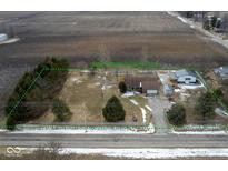 Expansive aerial view showcasing property lines, a well-kept home, and surrounding agricultural land at 7855 E 200 S Rd, Whitestown, IN 46075