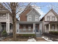 Brick and gray two-story home with front porch and landscaped yard at 927 Broadway St, Indianapolis, IN 46202