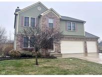 Two-story house with green siding, brick accents, and a two-car garage at 1271 N Manchester Dr, Greenfield, IN 46140