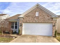 Brick ranch home with attached garage and landscaped yard at 15977 Marsala Dr, Fishers, IN 46037