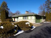 Ranch home with green exterior, attached garage, and landscaping at 2130 W 41St St, Indianapolis, IN 46228