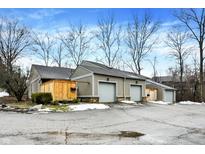 Exterior view of a townhouse with attached garage and private fenced area at 4218 Indian Pipe Trce, Indianapolis, IN 46237