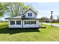 Charming two-story home with white siding, green shutters, and a well-maintained lawn at 4992 W 100 S, New Palestine, IN 46163