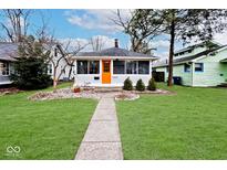 Charming single-story home with an orange front door and a well-maintained front yard at 5630 Winthrop Ave, Indianapolis, IN 46220