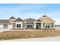 Modern craftsman style home with gray and yellow exterior, and a well-manicured lawn at 6207 Preserve Way, McCordsville, IN 46055