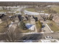 Aerial view of homes and street with snowy landscape at 7059 Koldyke Pl, Fishers, IN 46038