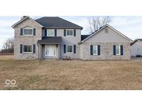 Charming two-story home with gray siding, blue shutters, and a well-maintained front yard at 9222 W State Road 38, Lapel, IN 46051