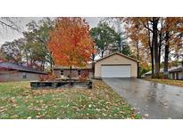 Ranch home with attached garage and autumn landscaping at 104 Rush Ct, Fishers, IN 46038